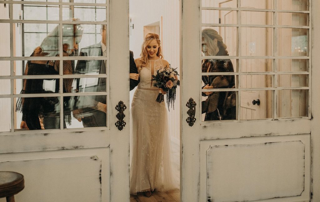 Bride Walking Aisle at barn Wedding